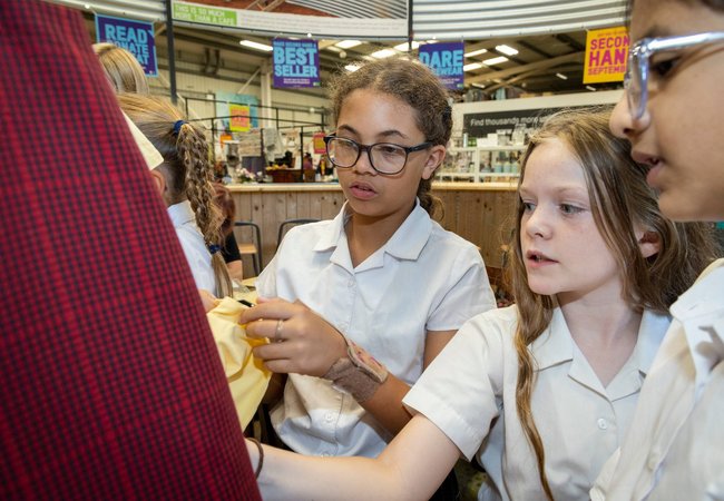 Pupils look through second-hand clothing at the Oxfam Superstore.