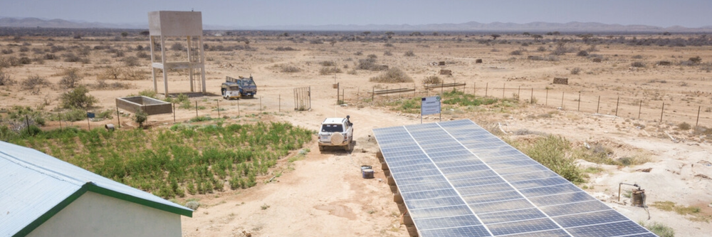 Dry landscape with a water tower and solar panels