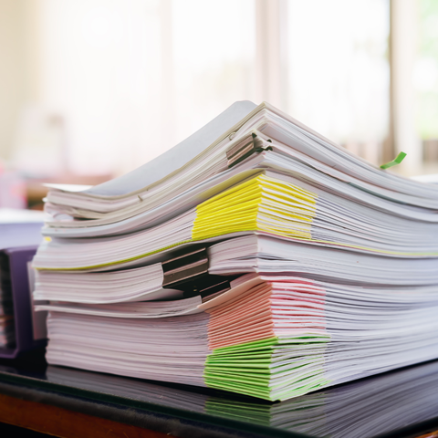 Pile of white papers piled on a desk