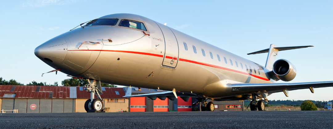 Private jet sitting on the tarmac with blue sky