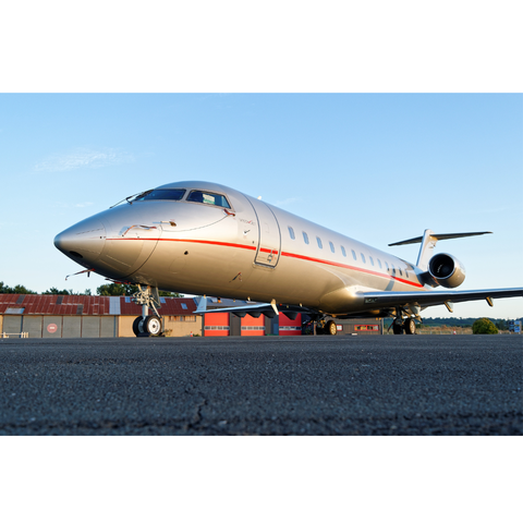 Private jet sitting on the tarmac with blue sky