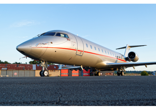 Private jet sitting on the tarmac with blue sky