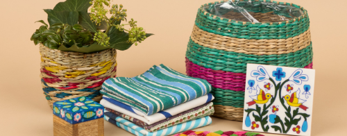 A gift bundle from Sourced by Oxfam, includes a colourful wicker plant pot, coasters, striped napkins and a floral trinket pot.