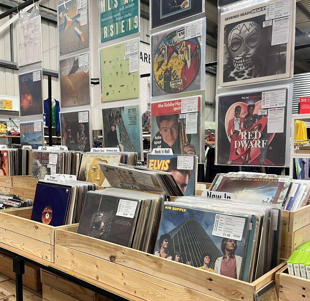 Vinyls in wooden trays and hung up at the Oxford Superstore. Artists such as Elvis Presley and Air Supply are shown.