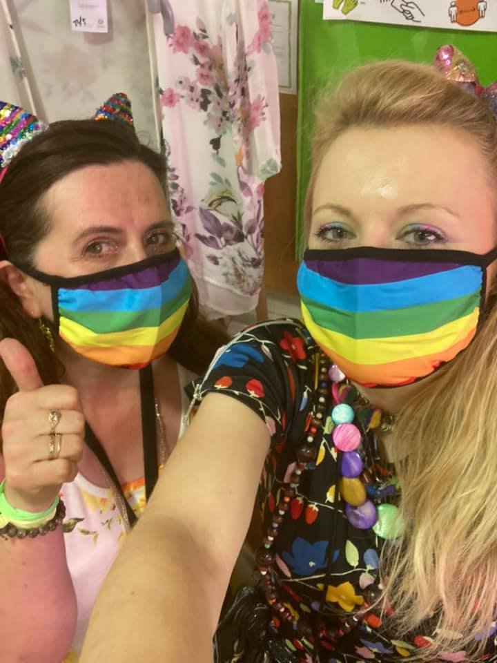 Volunteers Hannah and Delia who call themselves the two canaries wearing Pride flag facemasks