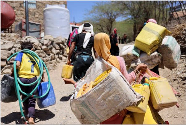 Children carry jerrycans of water instead of attending school—daily proof of how Yemen’s water crisis strips them of education and childhood.
