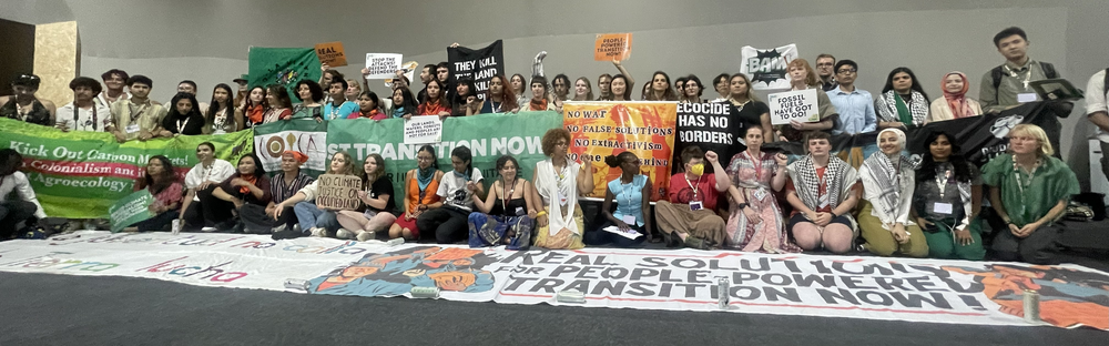 Youth Activists holding banners at COP30