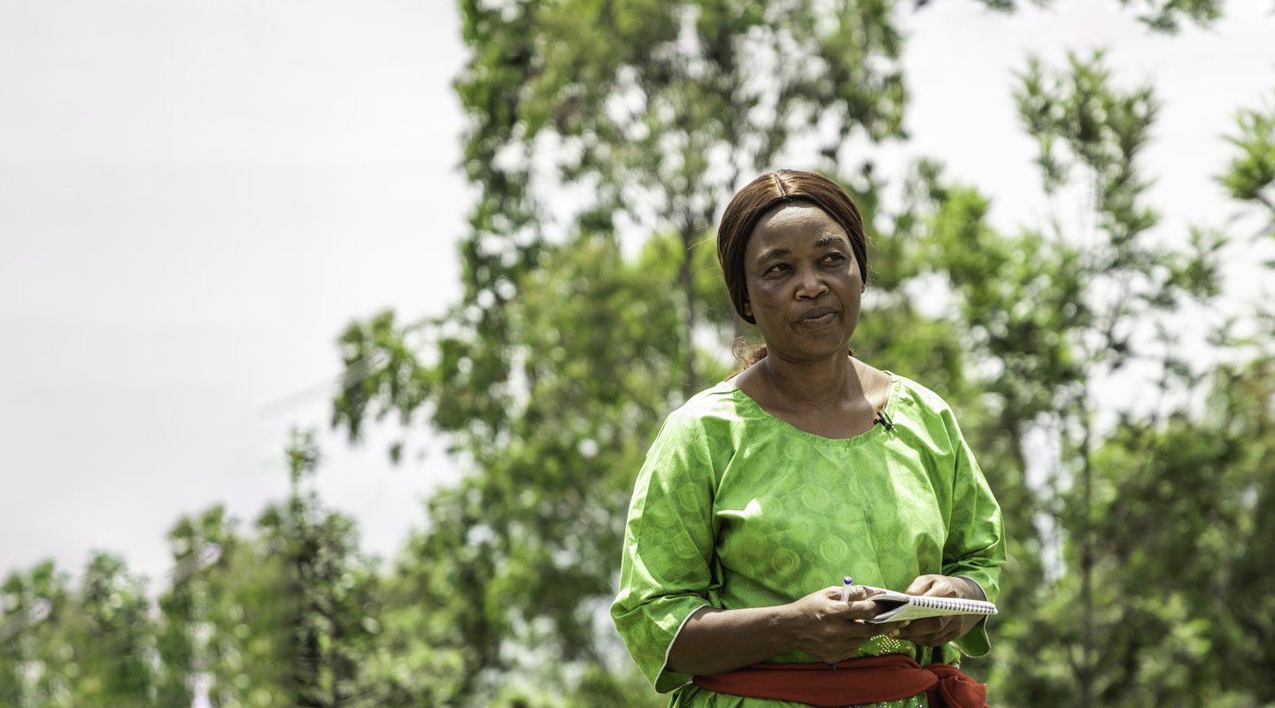 Zamuda Swayao Constance stands outside the chiefdom office in Burhinyi, South Kivu.