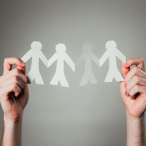 Paper people holding hands