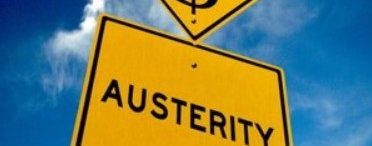 A yellow signpost with the word Austerity printed in black below another signpost of a dollar sign.