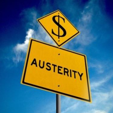 A yellow signpost with the word Austerity printed in black below another signpost of a dollar sign.