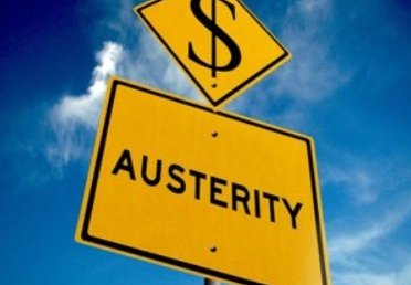 A yellow signpost with the word Austerity printed in black below another signpost of a dollar sign.