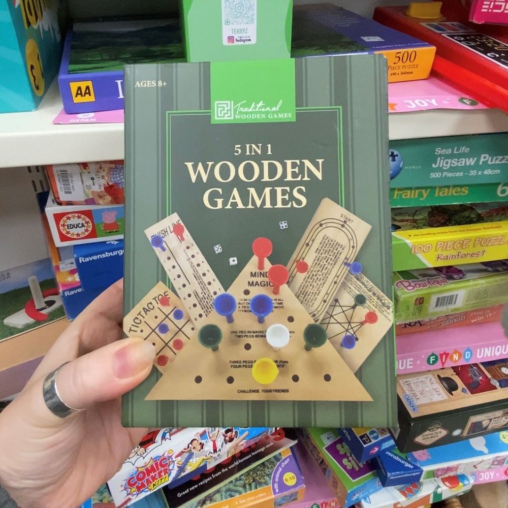 boardgame being held to show camera inside an Oxfam shop
