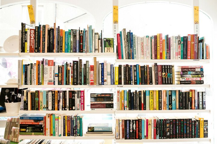 Lots of books on a book stand in an Oxfam shop