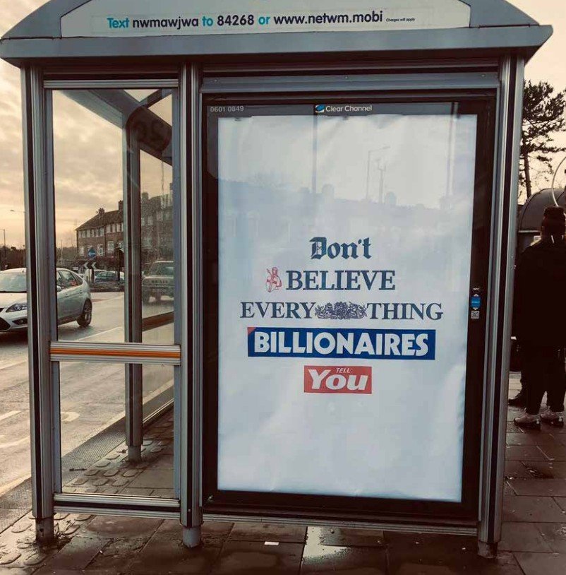 An advert on a bus stop in England that reads "don't believe everything billionaires tell you" in reference to billionaire owned media in the UK.