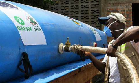 Modeste Mirindi connects the bladder to the taps of the new water point of the Elim Church in Bimbo, Central African Republic.