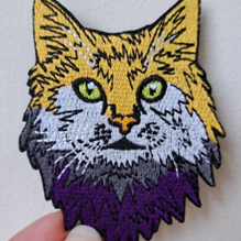 An iron-on patch in the shape of a tabby cat.