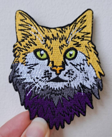An iron-on patch in the shape of a tabby cat.