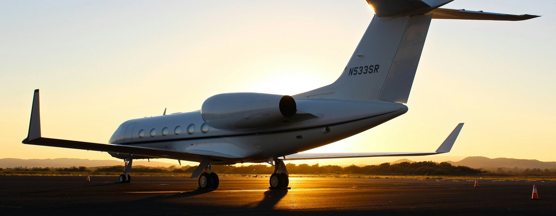 Private jet on the runway at sunset