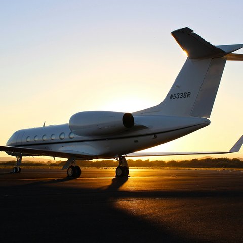 Private jet on the runway at sunset