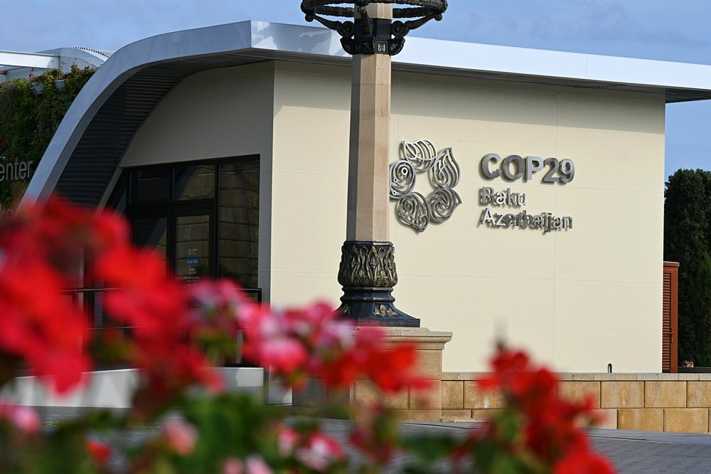 A sign reads 'COP29 Baku Azerbaijan' on a tourist information center on the Baku Boulevard.