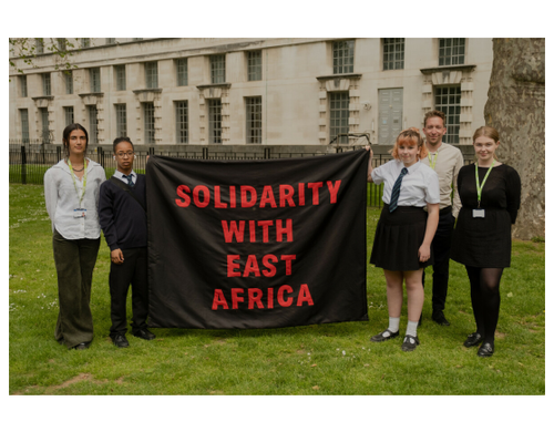 Amario and Mia, Send My Friend to School students, holding 'Solidarity with East Africa' banner alongside Oxfam staff before petition hand in at Number Ten Downing Street.