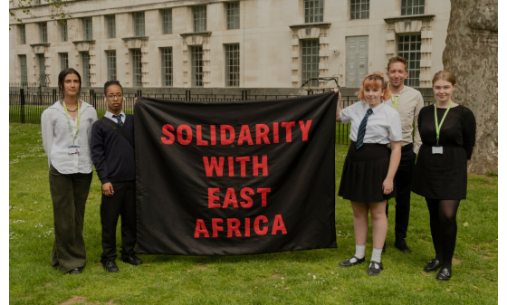 Amario and Mia, Send My Friend to School students, holding 'Solidarity with East Africa' banner alongside Oxfam staff before petition hand in at Number Ten Downing Street.