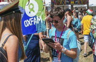 A festival campaigner talking to a festival goer.
