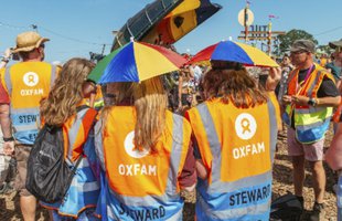 Oxfam volunteers with umbrellas