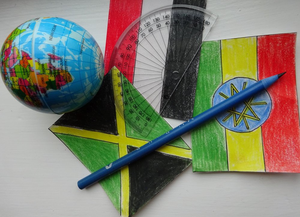 A protractor, pencil and some hand drawn pictures of flags.