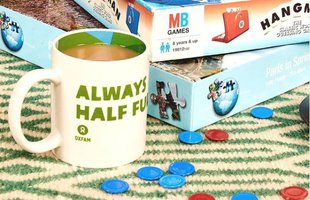 a selection of board games and a cup of tea with the message 'always half full' on