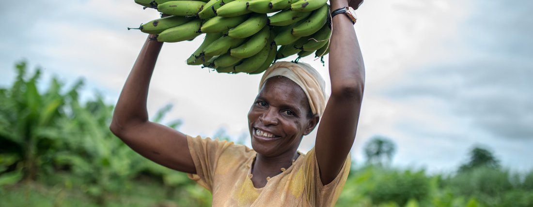 Idah, a member of the Kabwadu women's club, holds a bunch of bananas in Chirundu district, Zambia.