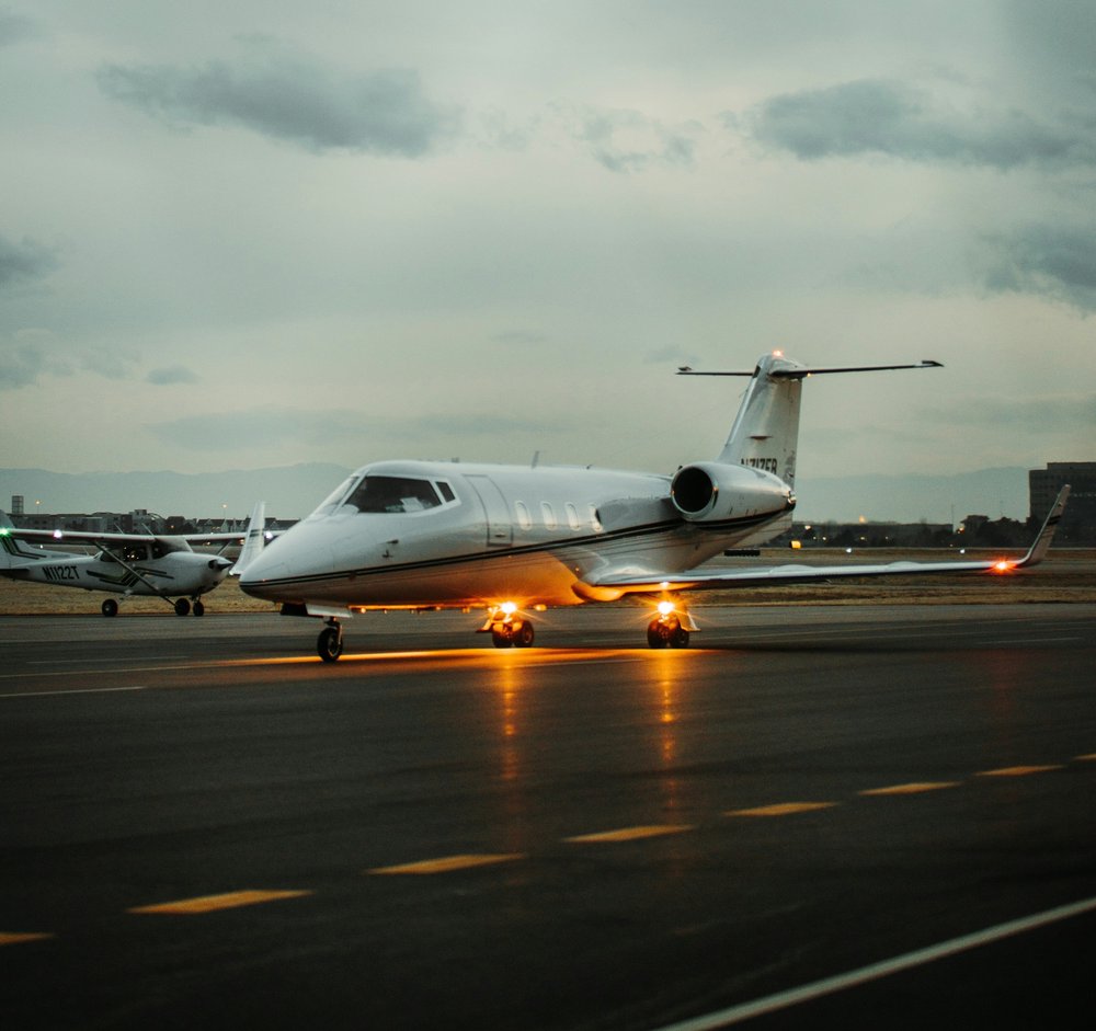 Private jet on runway at sunset