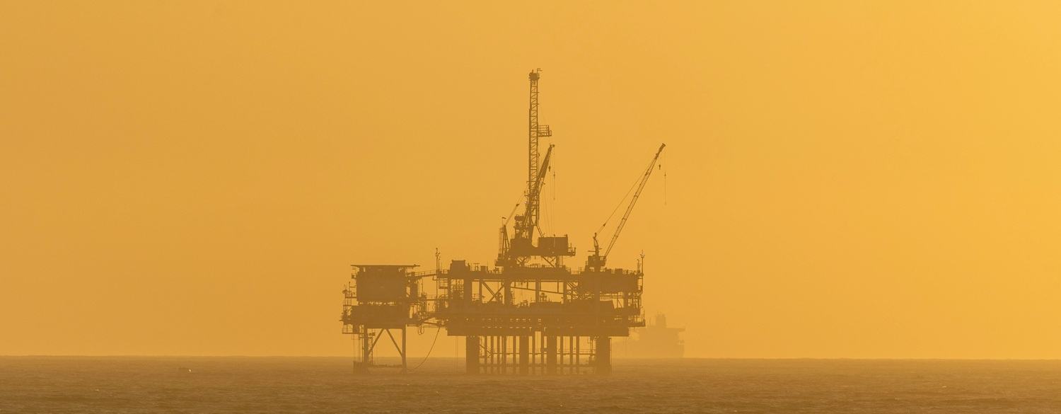 Oil rig at sunset in the sea