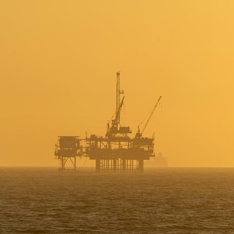 Oil rig at sunset in the sea