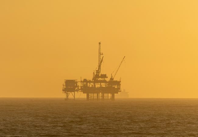 Oil rig at sunset in the sea