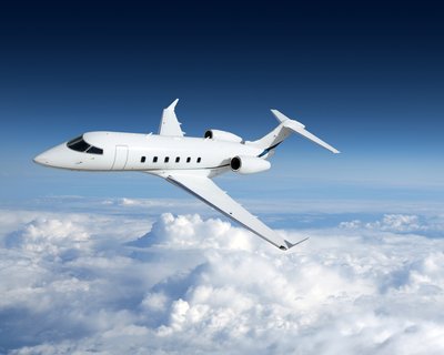 Business jet airplane flying on a high altitude above the clouds