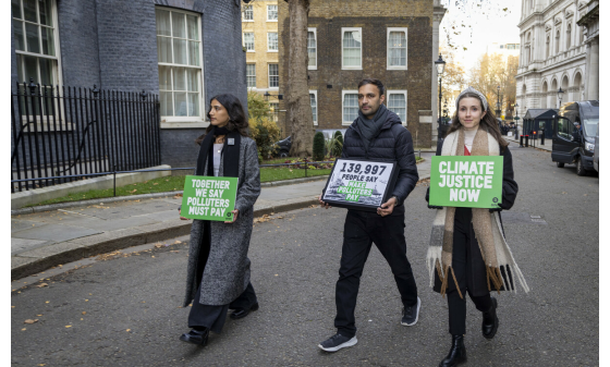 Campaigners handing in Oxfam's Make Rich Polluters Pay petition at 10 Downing Street, London.