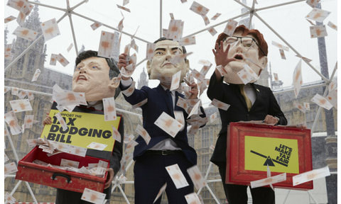 Campaigners from the Tax Dodging Bill campaign dressed up as George Osborne, Ed Balls and Danny Alexander, holding budget boxes to take part inside a cash grab inside a crystal maze style dome to represent the vast amounts of cash lost to tax dodging.
