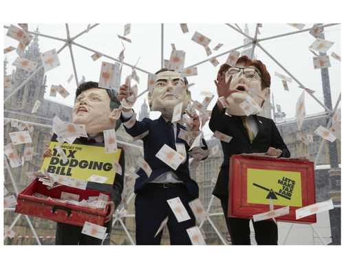 Campaigners from the Tax Dodging Bill campaign dressed up as George Osborne, Ed Balls and Danny Alexander, holding budget boxes to take part inside a cash grab inside a crystal maze style dome to represent the vast amounts of cash lost to tax dodging.