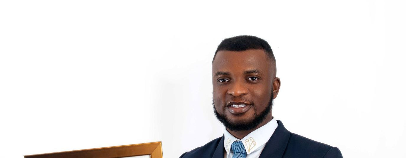 Legal professional Michael Ezimoha holds a framed certificate