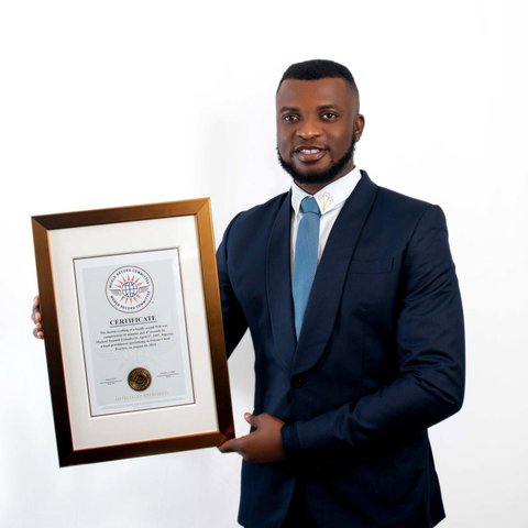Legal professional Michael Ezimoha holds a framed certificate