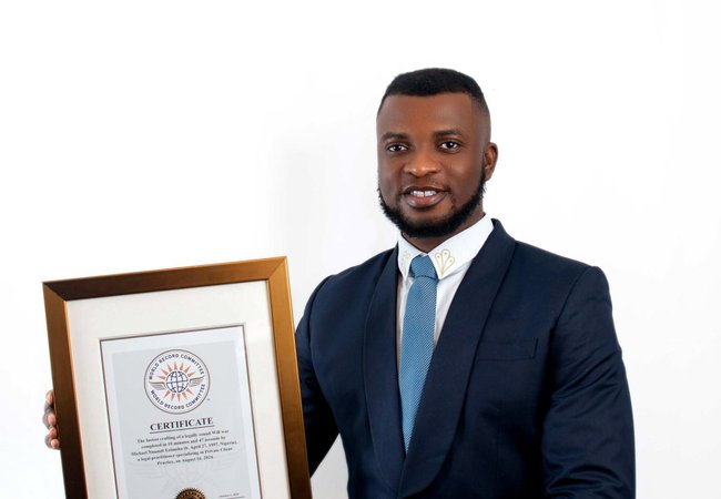Legal professional Michael Ezimoha holds a framed certificate