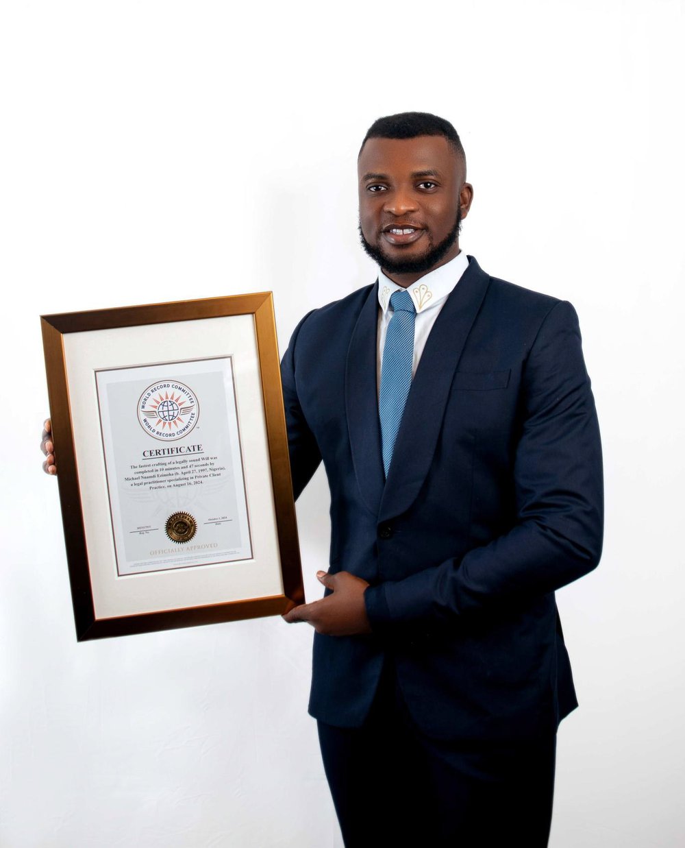 Legal professional Michael Ezimoha holds a framed certificate