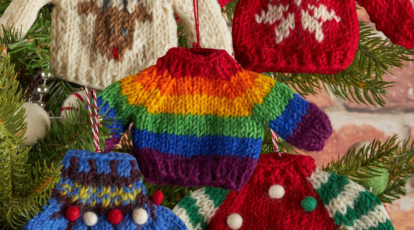A montage of five Christmas decorations shaped like jumpers