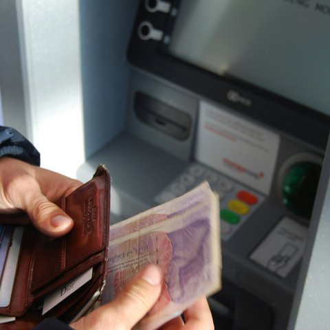 Person withdrawing money from ATM