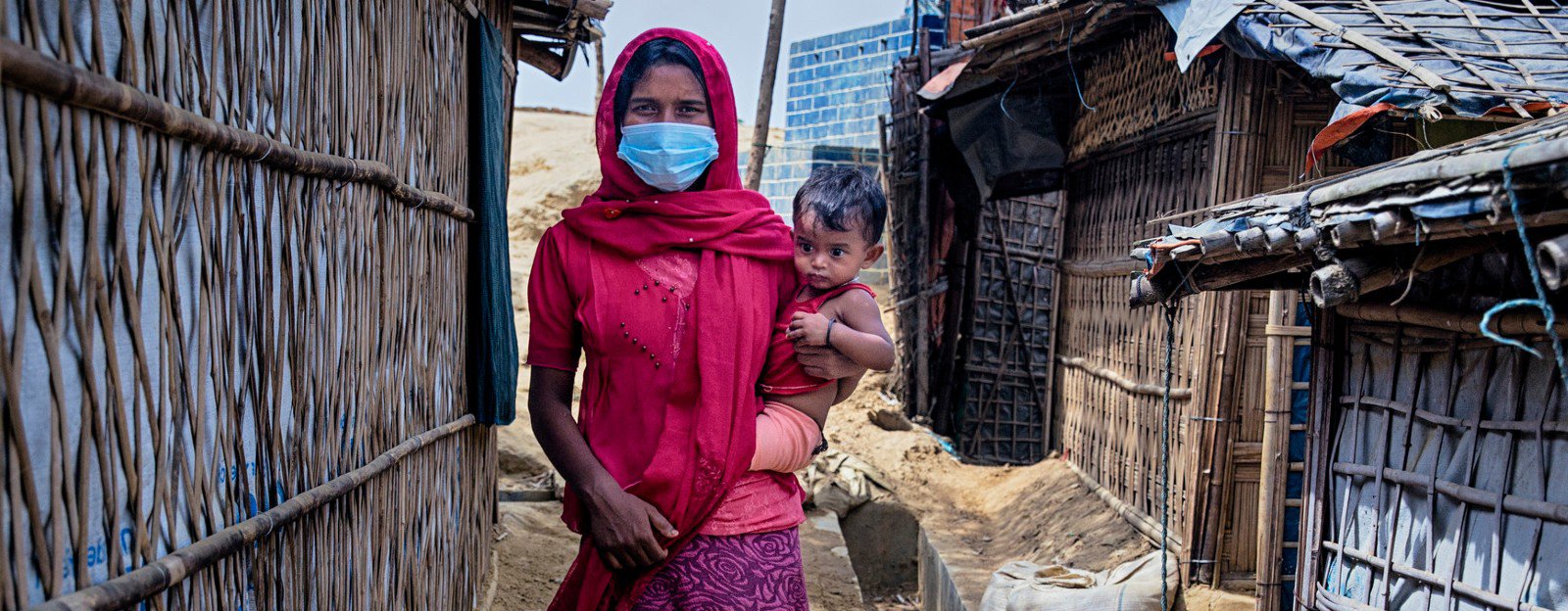 Walking through the narrow alley between tents. Rohingya refugee camp. Cox's Bazar, Bangladesh
