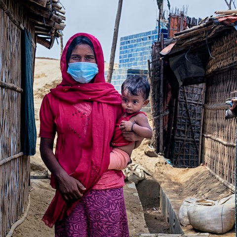 Walking through the narrow alley between tents. Rohingya refugee camp. Cox's Bazar, Bangladesh