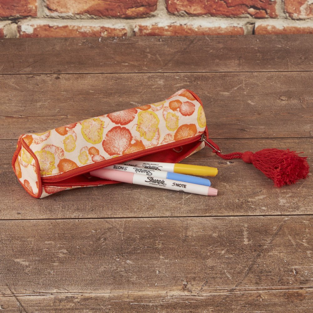 pencil case with a mushroom print on orange fabric
