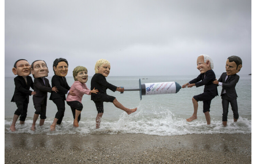Campaigners from Oxfam and The People’s Vaccine Alliance pose as world leaders at the G7 summit in Cornwall, 2021.
